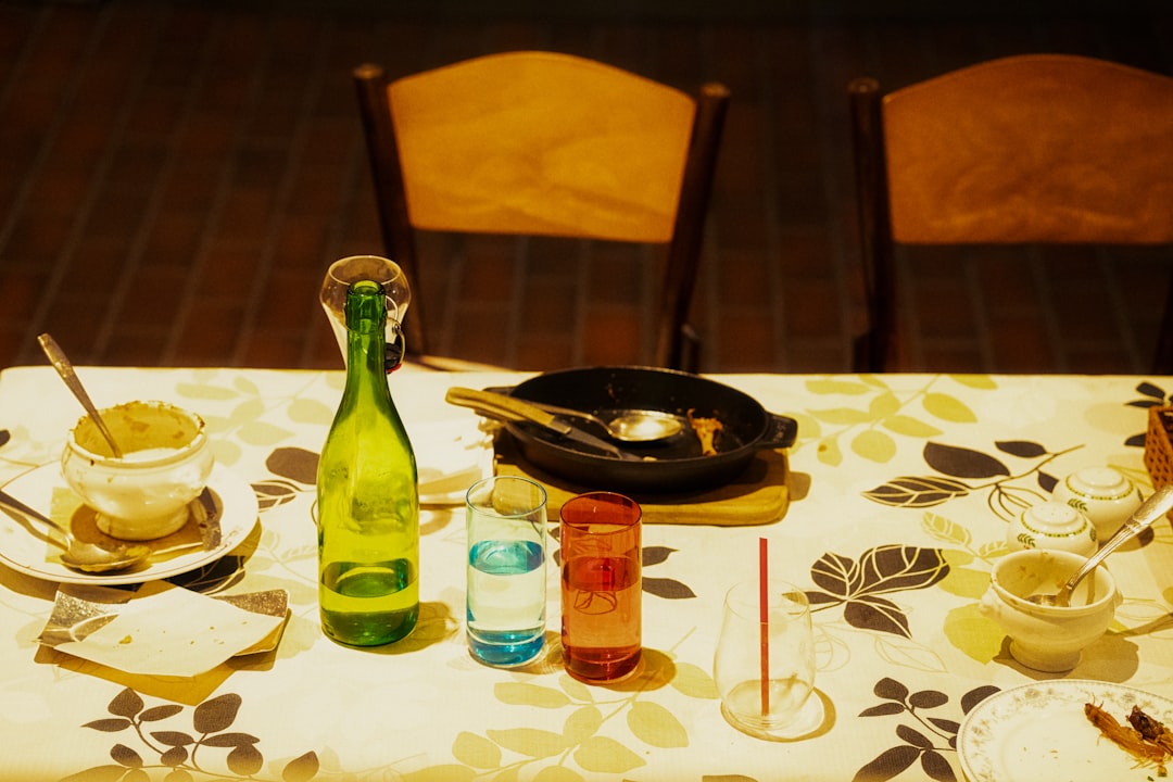 hero-img a-table-topped-with-a-bottle-of-wine-next-to-a-plate-of-food-iq9z9fyitue